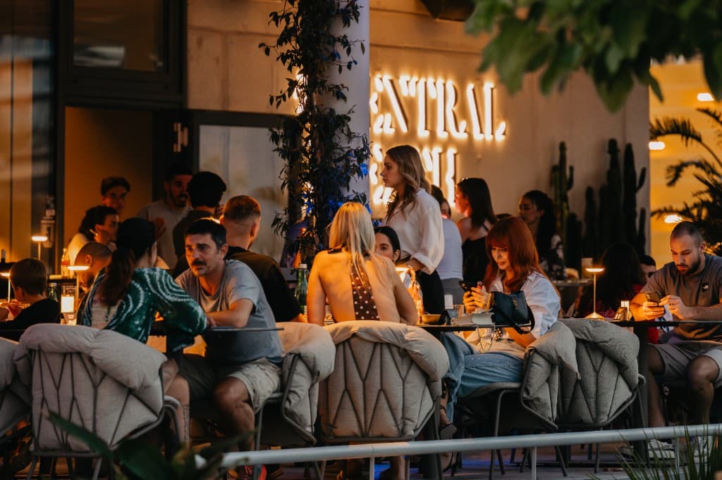 Central Beach Split terrace at golden hour, guests over drinks on Žnjan beach