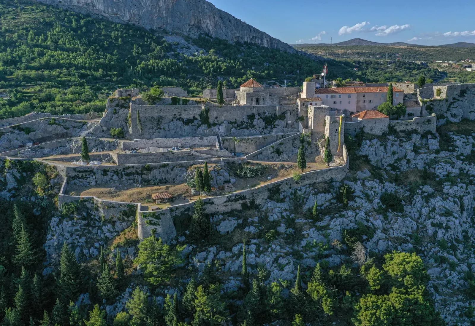 Medieval Klis Fortress on a rocky ridge above Split at golden hour, the Game of Thrones Meereen location, Croatia