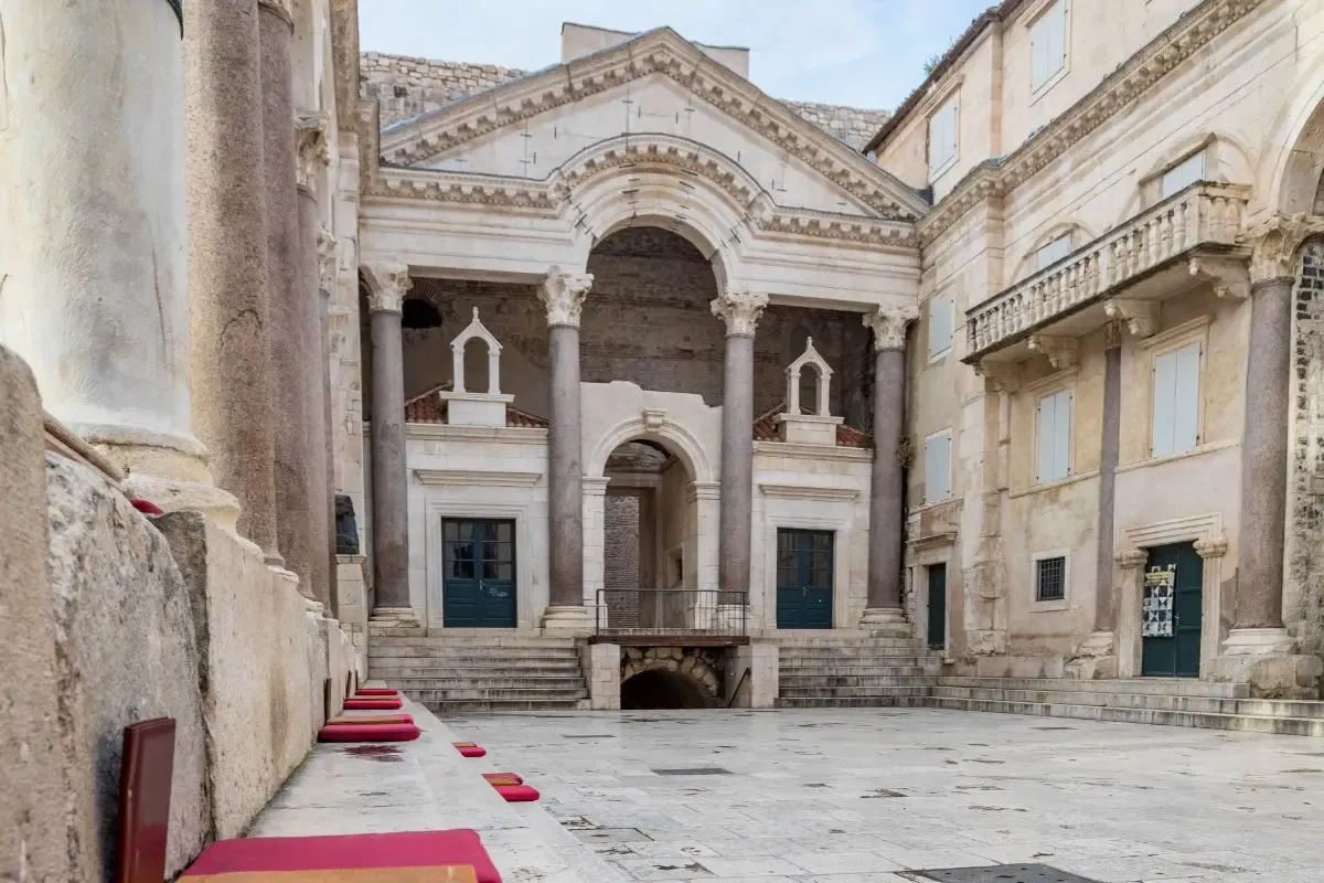 The Peristyle square inside Diocletian's Palace in Split's old town, lined with cafe cushions