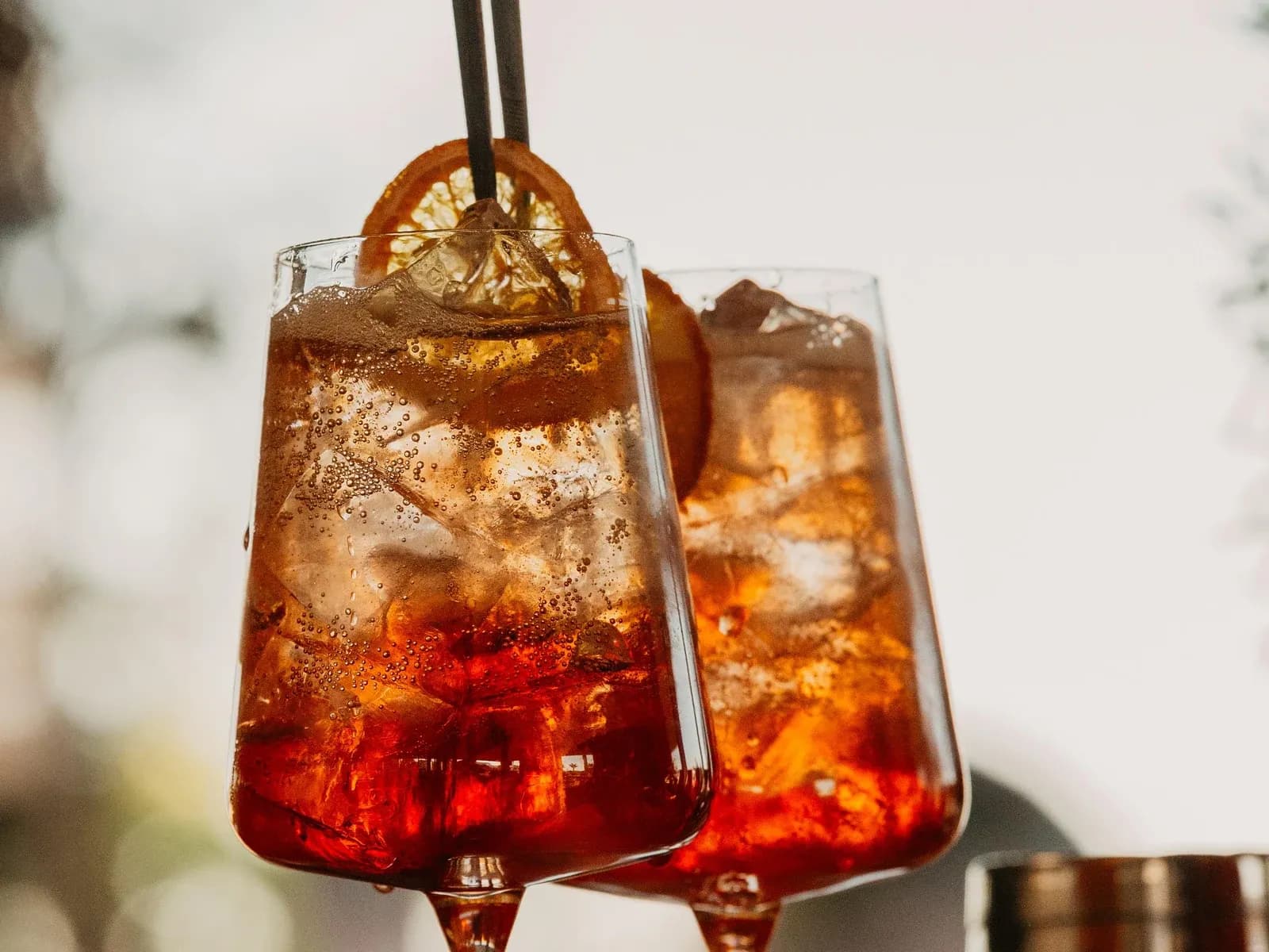 Two spritz cocktails with dried orange garnish on the bar at Central Beach Split, Croatia, in late afternoon light